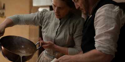 Juliette Binoche as “Eugénie” and Benoît Magimel as “Dodin” in Tran Anh Hung’s "The Taste of Things." (Stéphanie Branchu)
