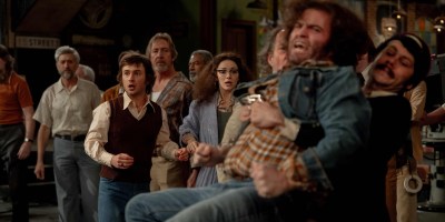 From left, Lorne Michaels (Gabriel LaBelle) and Gilda Radner (Ella Hunt) watch John Belushi (Matt Wood) and Dan Aykroyd (Dylan O'Brien) get into it. (Sony Pictures)