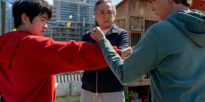 Ralph Macchio, Ben Wang and Jackie Chan in “Karate Kid: Legends.” (Sony Pictures)